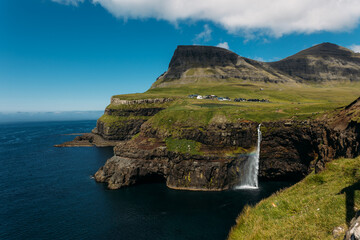 Faroe Islands Panorama of the iconic natural Mulafossur - Mulafossur Waterfall and Gasadalur village on Vagar Island