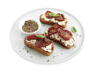 Delicious ricotta bruschettas with sun dried tomatoes, basil and milled pepper isolated on white