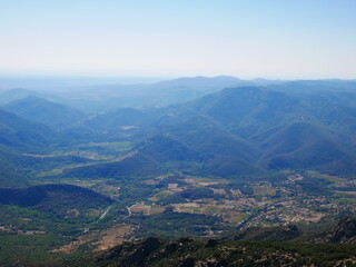 Panorama of a green mountain under cloudy skies in the south of France