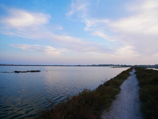 Sunset on a pond in Frontignan, south of France, view of a path