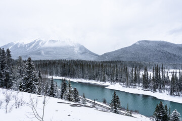 Bow River in Banff National Park during winter with snowy landscape.