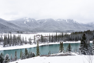 Bow River in Banff National Park during winter with snowy landscape.