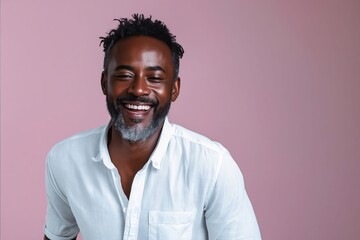 Fototapeta premium A smiling black man with beard and white shirt.