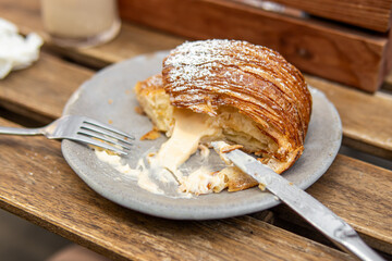 Sliced croissant with filling. Croissant in cafe. Soft focus