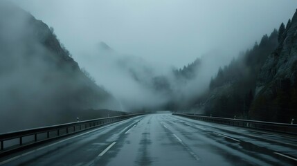 Highway in foggy mountains, low visibility, dangerous driving conditions