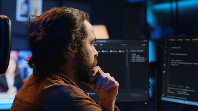 Software engineer puzzled in front of computer screen while writing complex code. Admin feeling confused while trying to fix database errors while working from home, camera A close up