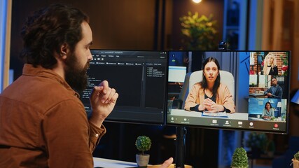 Teleworking computer scientist talking with multiethnic team during online videocall, discussing...