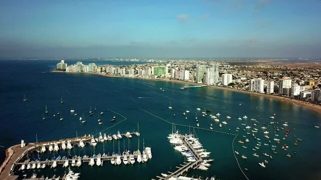 Panoramic aerial shot of beach coast with boats in Salinas, Ecuador - 4K