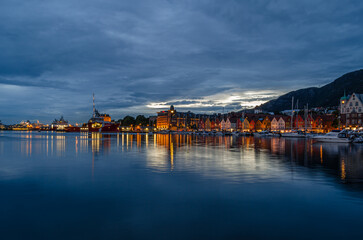 View of Vagen harbor and the colorful buildings of Bryggen at dusk in Bergen, Norway