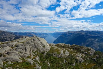 Fototapeta premium Hiking to Pulpit Rock, a location with views over the Lysefjord, involves a 4-5 hour hike with stunning views of the fjord
