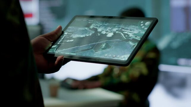 Military personnel in high tech environment safeguard classified information, monitor cybersecurity threats and digital warfare operations to protect against attacks and data breaches. Camera A.