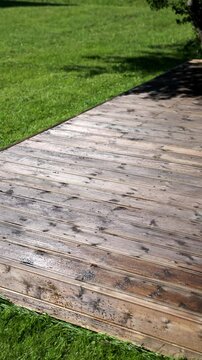Freshly painted backyard terrace with sandbox in a green garden