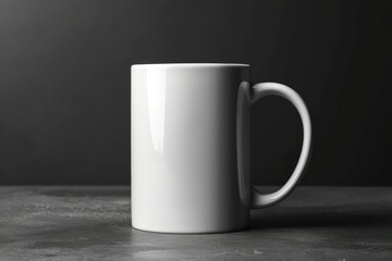 Obraz premium Minimalistic white coffee mug centered on a dark textured surface with soft lighting