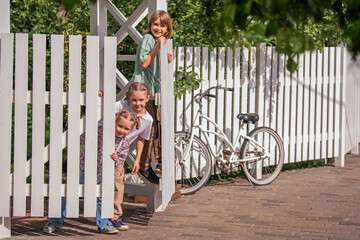 All the children open the gate to the fence of the country house and go out to the meeting.