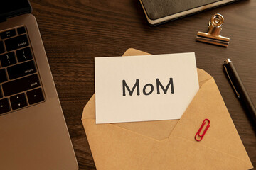 There is word card with the word MoM. It is an abbreviation for month over month as eye-catching...