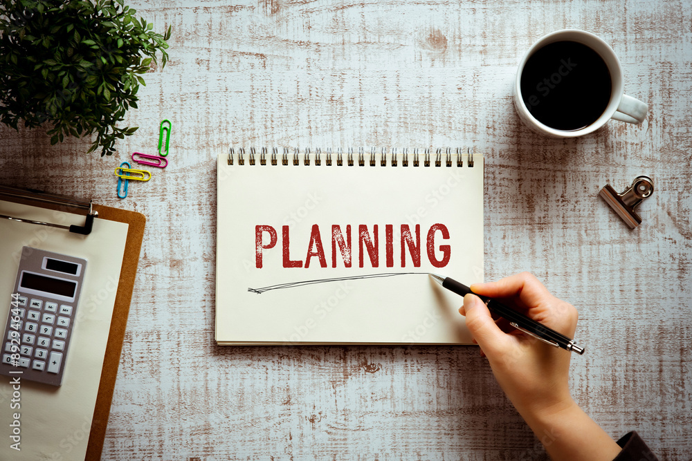 Poster there is notebook with the word planning. it is as an eye-catching image.