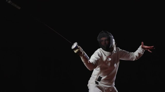 Figure Of Professional Swordsman In Darkness, Moving And Fighting, Practicing Attack