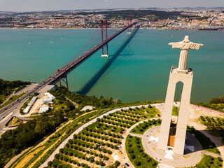 Aerial panorama view over the 25 de Abril Bridge and Statue of Jesus, Portugal