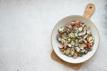Clams with white wine, garlic and parsley, top view, copy space