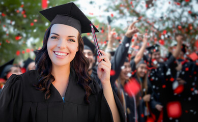 Young Female Graduate Celebrating Her Graduation with Her Fellow Classmates Outdoors.