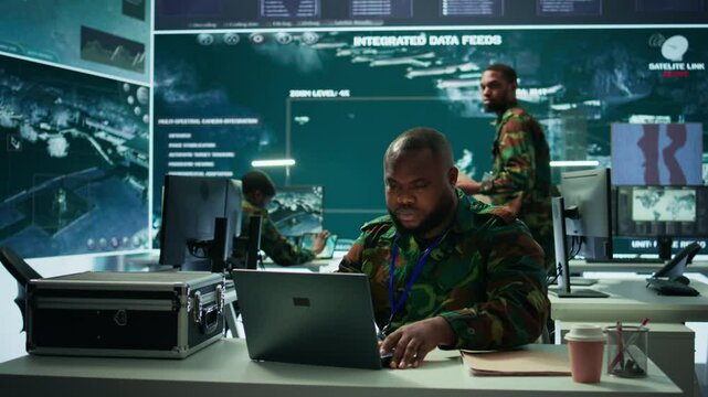 Army intelligence expert utilizes modern computer systems and satellite radar imagery to enhance national security, strategic initiatives and ensure defense in mission control center. Camera B.