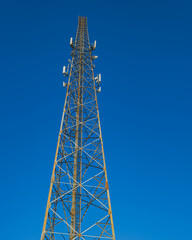 Tall Telecommunication Tower Against a Clear Blue Sky