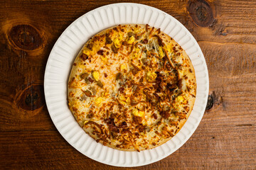 breakfast pizza with sausage and scrambled eggs
