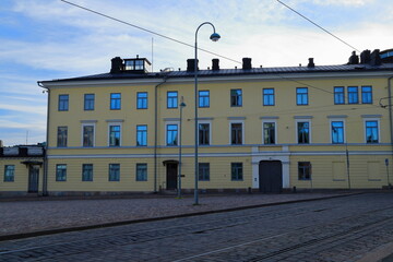Yellow building and street in the Finnish capital. Summer day in June. Helsinki, Finland. 