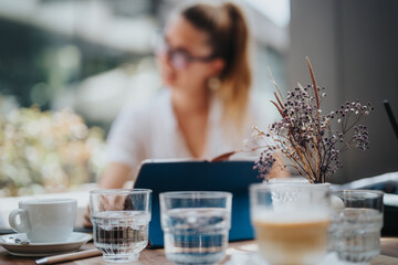 Startup team in a business meeting, discussing strategy and brainstorming ideas over coffee at a modern cafe setting.