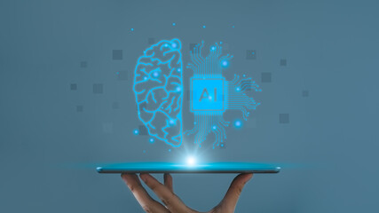 Hand holding a tablet with a glowing digital brain and chip, symbolizing artificial intelligence...