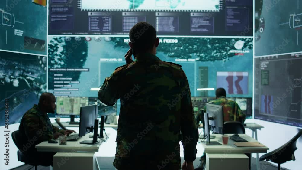 Poster military man answers phone call in a mission control center, working with advanced technology and sa