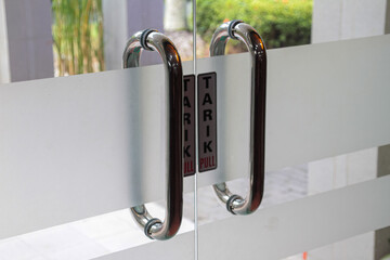 Aluminum door handle in modern interior style in interior office or factory