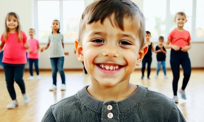 Medium shot portrait video of a grinning child male that is wearing a chic cardigan against an energetic zumba class with participants dancing background