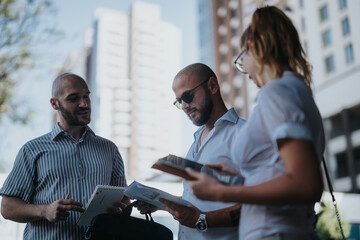 A team of marketing workers in an outdoor meeting discussing campaign performance, market trends,...