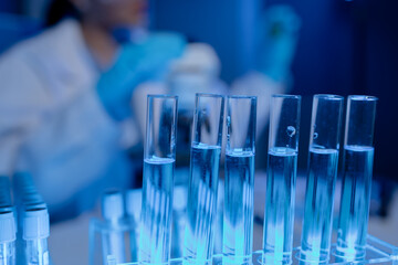 scientist is working on an important liquid inside tube in laboratory, the discovery of a vaccine to protect against currently spreading virus has been discovered, wear gloves and goggles for safety