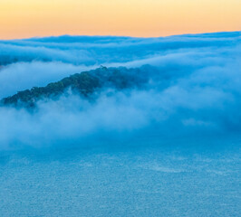 Mountain range enveloped by fog