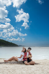 Fototapeta premium Couple lover playing guitar singing together dating on tropical summer beach. Two people dating together romantic moment with happiness romance. girlfriend boyfriend on beach guitarist hobby seaside
