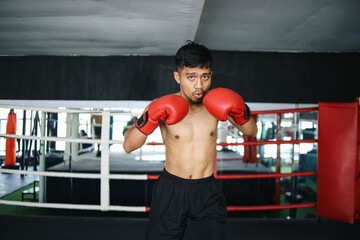 Young Asian Fighters Man With Red Boxing Gloves Doing Stance And Fighting Movement In Boxing Ring