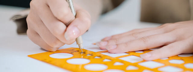 The architect used a pencil, ruler, and compass to meticulously create the blueprint, ensuring...