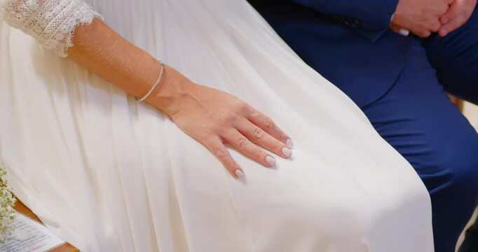 Close up uf unrecognizable bride and groom holding hands, left to right panning shot - 2.7K 60fps 