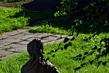 Sunlight on statue in garden, canyon, Texas.