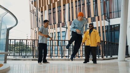 Hip hop team dance break dance while multicultural friend surrounded and clapping hands to cheer or encourage his friend to dance. Active and energetic street dance. Outdoor sport 2024. Hiphop.