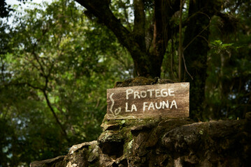 Signboard on the edge of a rural trail frequented by tourists with the message Protect wildlife,...