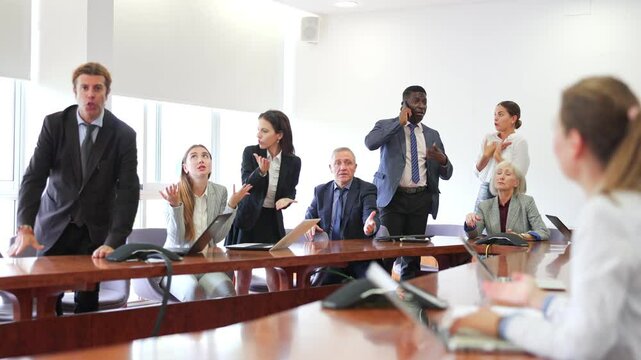  Group of diverse business persons having quarrel in conference room.