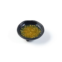 Seafood Dipping Sauce (Green Chili and Lime) on black dish isolated on white background. spicy and sour taste.