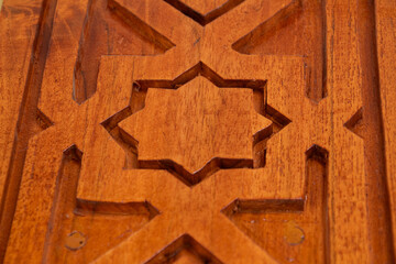 Arabic calligraphy of Allah's names in wood carvings, mosque decoration wooden doors