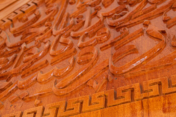 Arabic calligraphy of Allah's names in wood carvings, mosque decoration wooden doors