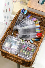 A collection of colorful nail polish swatches in a basket, showcasing a variety of vibrant shades.