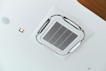 Ceiling-mounted air conditioner with integrated light, showcasing modern HVAC design.