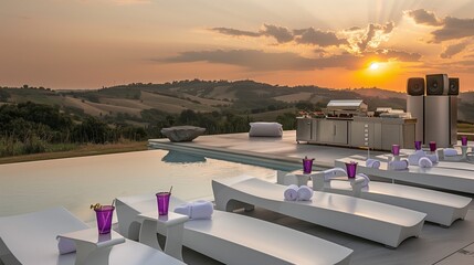 Chic poolside celebration with white modern loungers, purple drinks, upscale food stand, and a sophisticated silver sound system as the sun sets over rolling hills